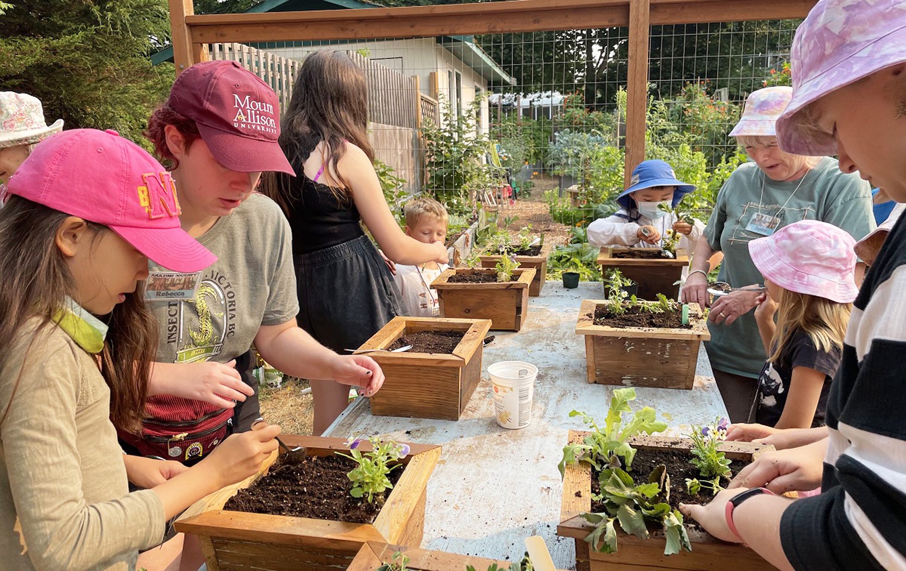 The campers and volunteers working on their planters.